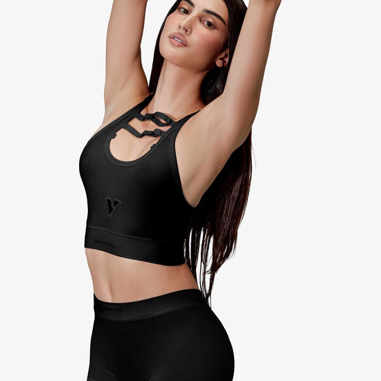 Woman modeling the black smooth-knit Sculpt Jockstrap 3" trunk, front pose with arms up — Color: Black