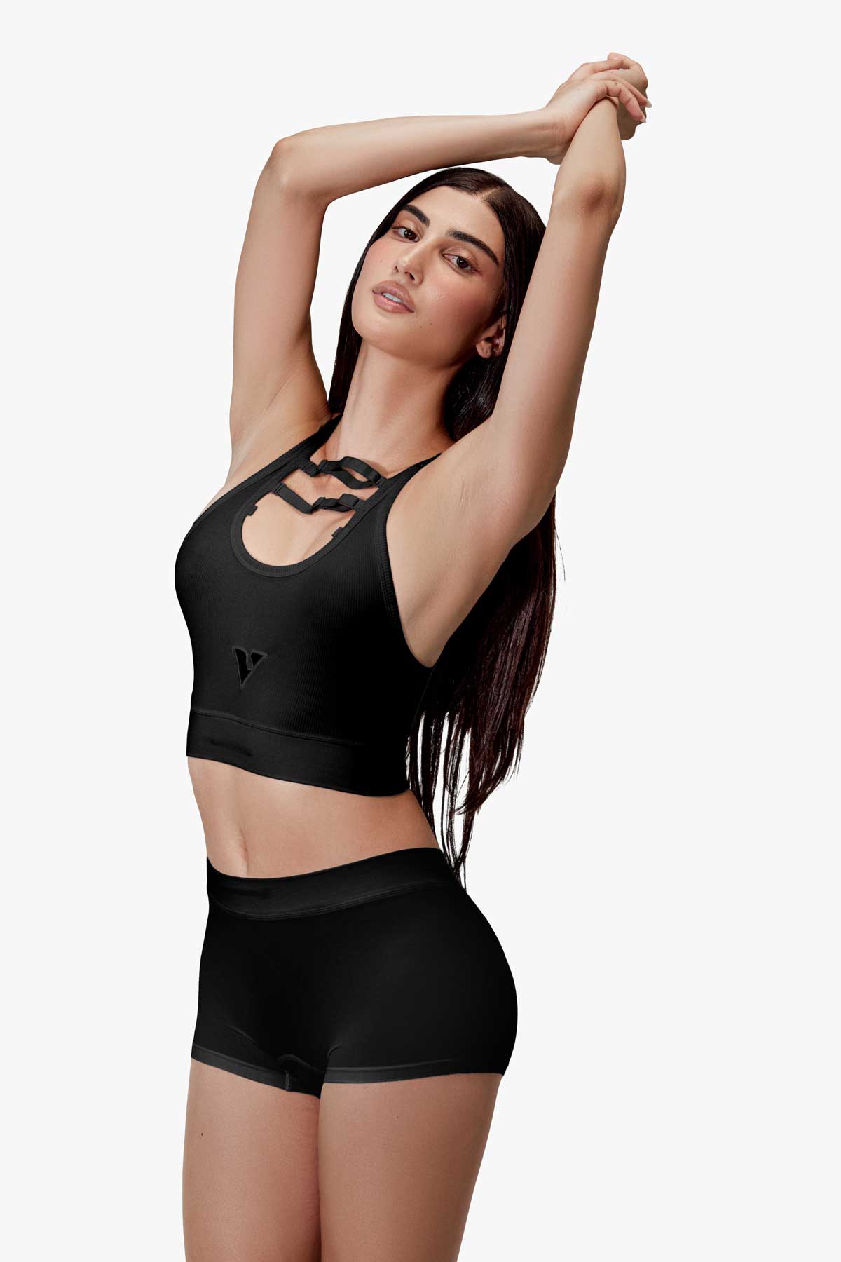 Woman modeling the black smooth-knit Sculpt Jockstrap 3" trunk, front pose with arms up — Color: Black