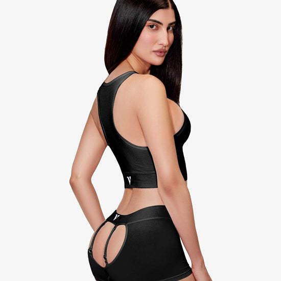 Women’ modeling the black smooth-knit Sculpt Jockstrap 3" trunk, three-quarter rear view — Color: Black