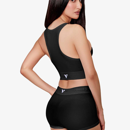 Woman modeling the black Sculpt Jockstrap 3" Trunk with removable straps, three-quarter back view — Color: Black