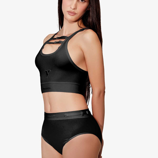 Model wearing Women’s black rib-knit underwear, Core Rib Brief, three-quarter tuned pose — Color: Black