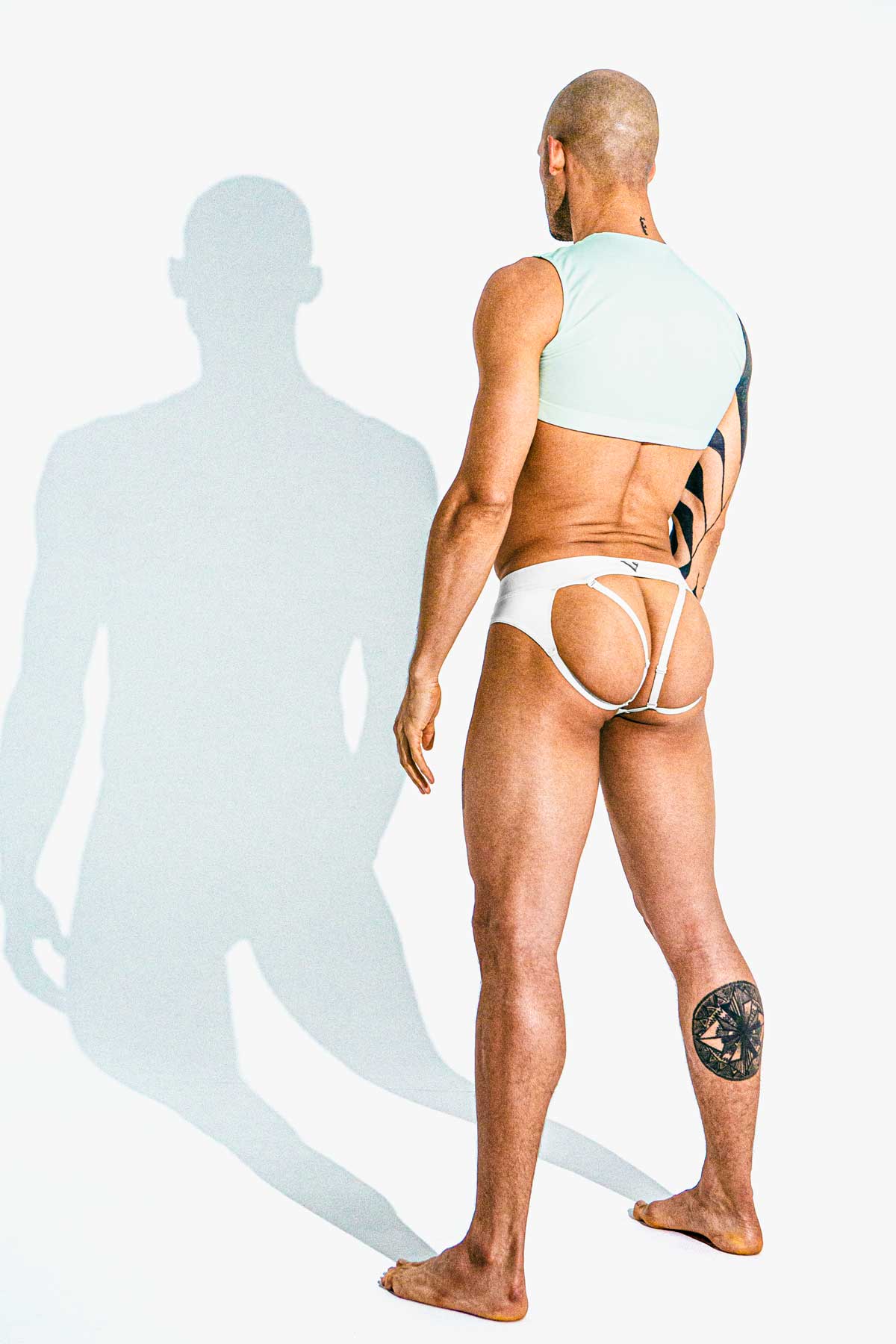 Man modeling the white Sculpt Jockstrap Brief with removable straps, back view — Color: White