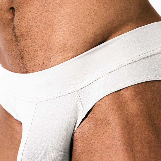 Close-up of the white Sculpt Jockstrap Brief’s smooth pouch, front view — Color: White
