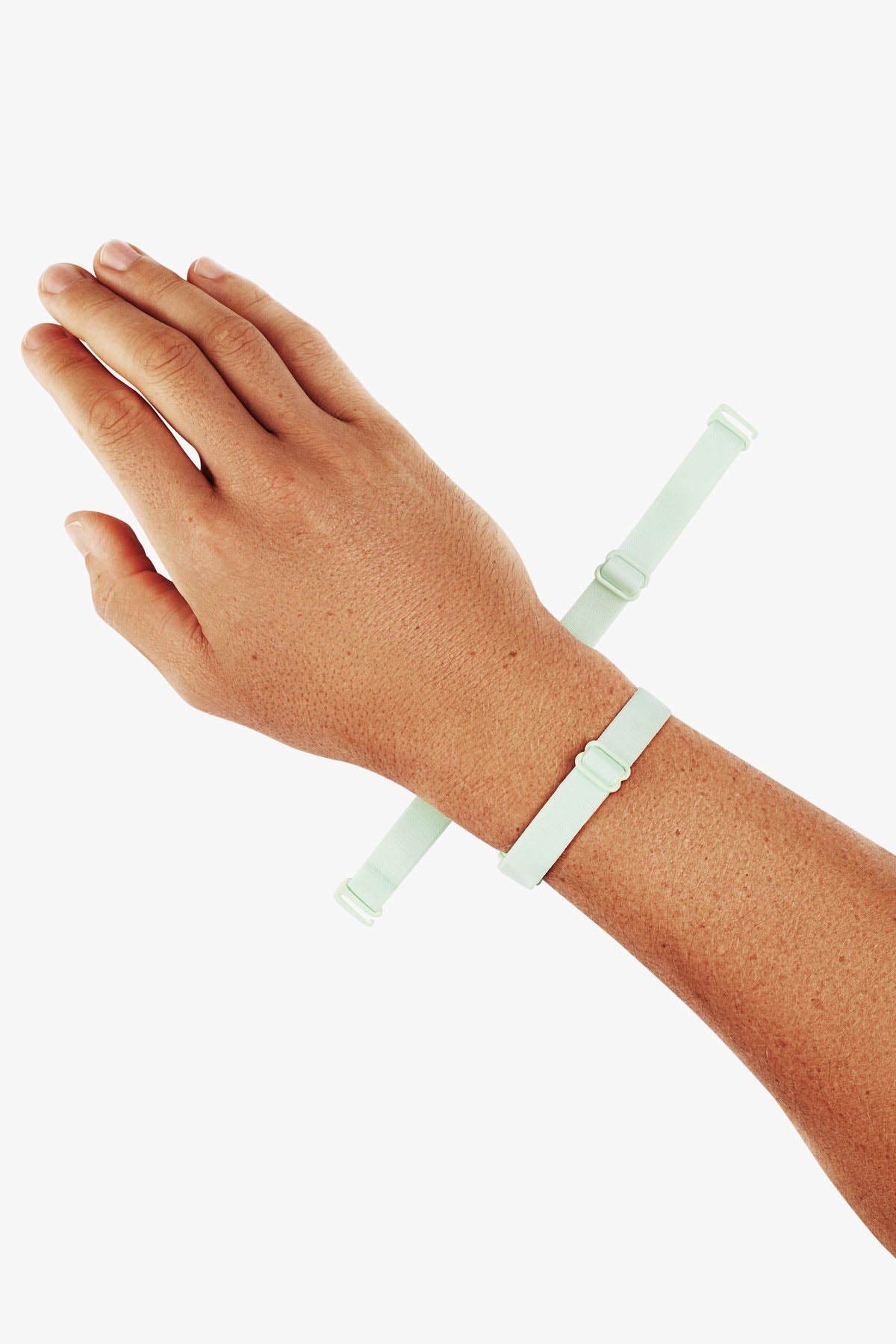 Virtue Genderless Strap Mint Color Worn as Hand Cuff on Model wrist designed to be worn in different configurations strap sculpt squeeze