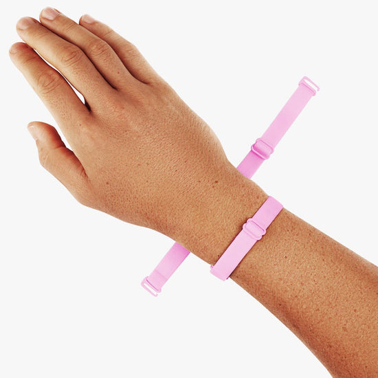 Virtue Genderless Strap Taffy Color Worn as Hand Cuff on Model wrist designed to be worn in different configurations strap sculpt squeeze