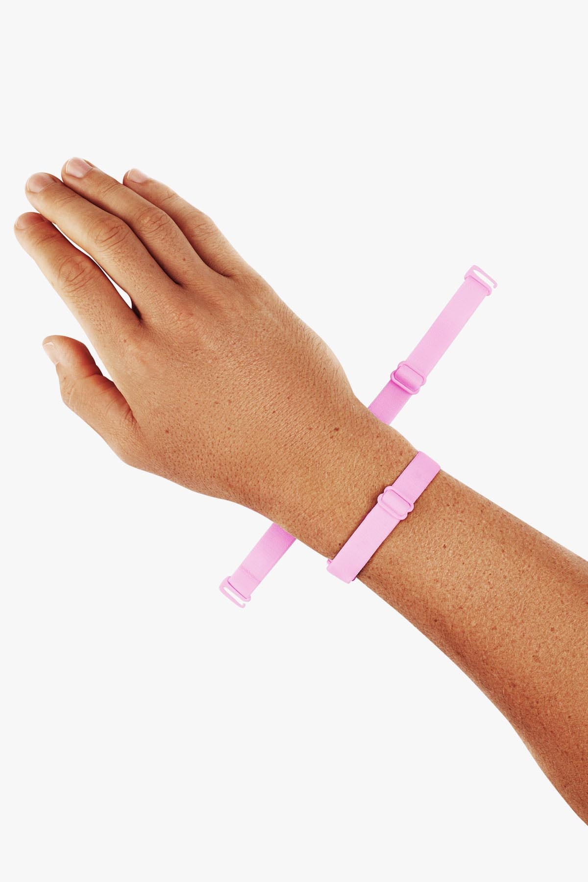 Virtue Genderless Strap Taffy Color Worn as Hand Cuff on Model wrist designed to be worn in different configurations strap sculpt squeeze
