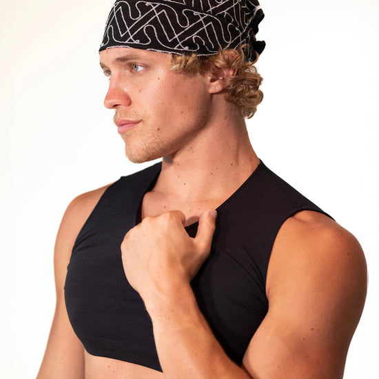 Close-up of a model wearing the black Mini Crop Top, side-front view — Color: Black