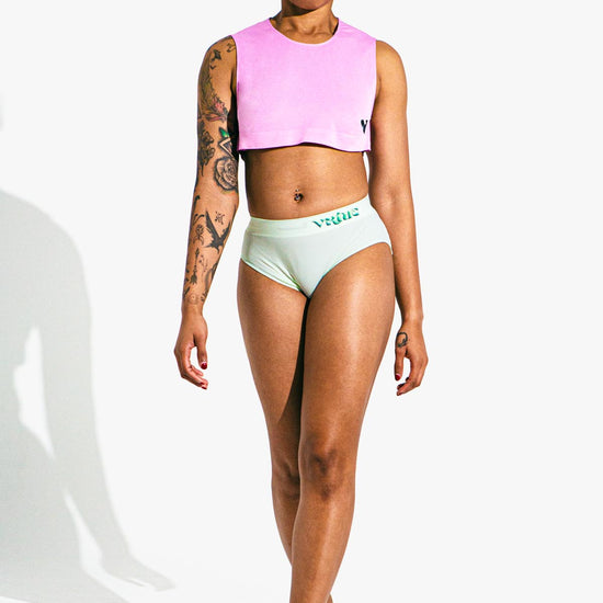 Virtue Model Karma posing in Virtue Taffy Sheer Knit Crop Top and Mint Rib Knit Compact Fit Strap Brief Front View