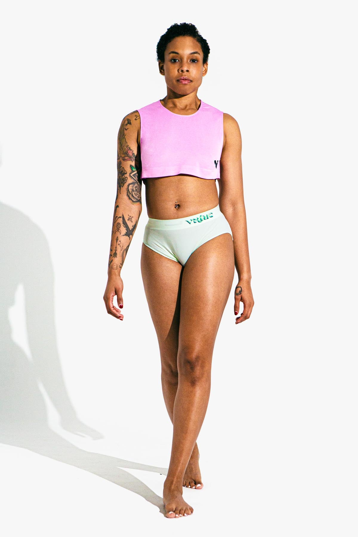 Virtue Model Karma posing in Virtue Taffy Sheer Knit Crop Top and Mint Rib Knit Compact Fit Strap Brief Front View