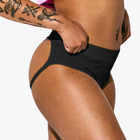 Close-up of a woman modeling the black Sculpt Jockstrap Rib Brief, side-front fit — Fabric: Rib — Color: Black