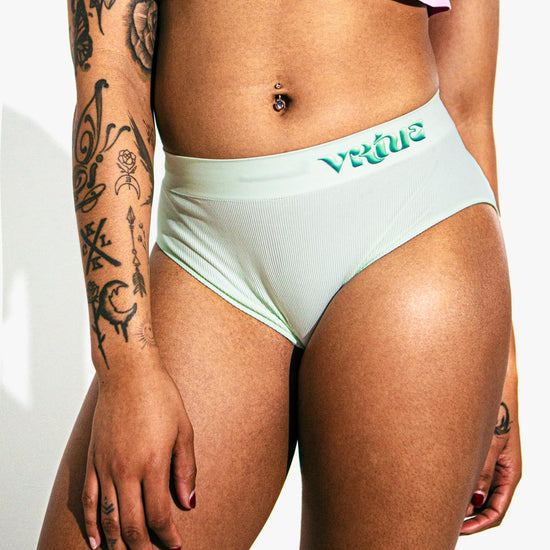 Virtue Model posing in Virtue Taffy Sheer Knit Crop Top and Mint Rib Knit Compact Fit Strap Brief Front View Close