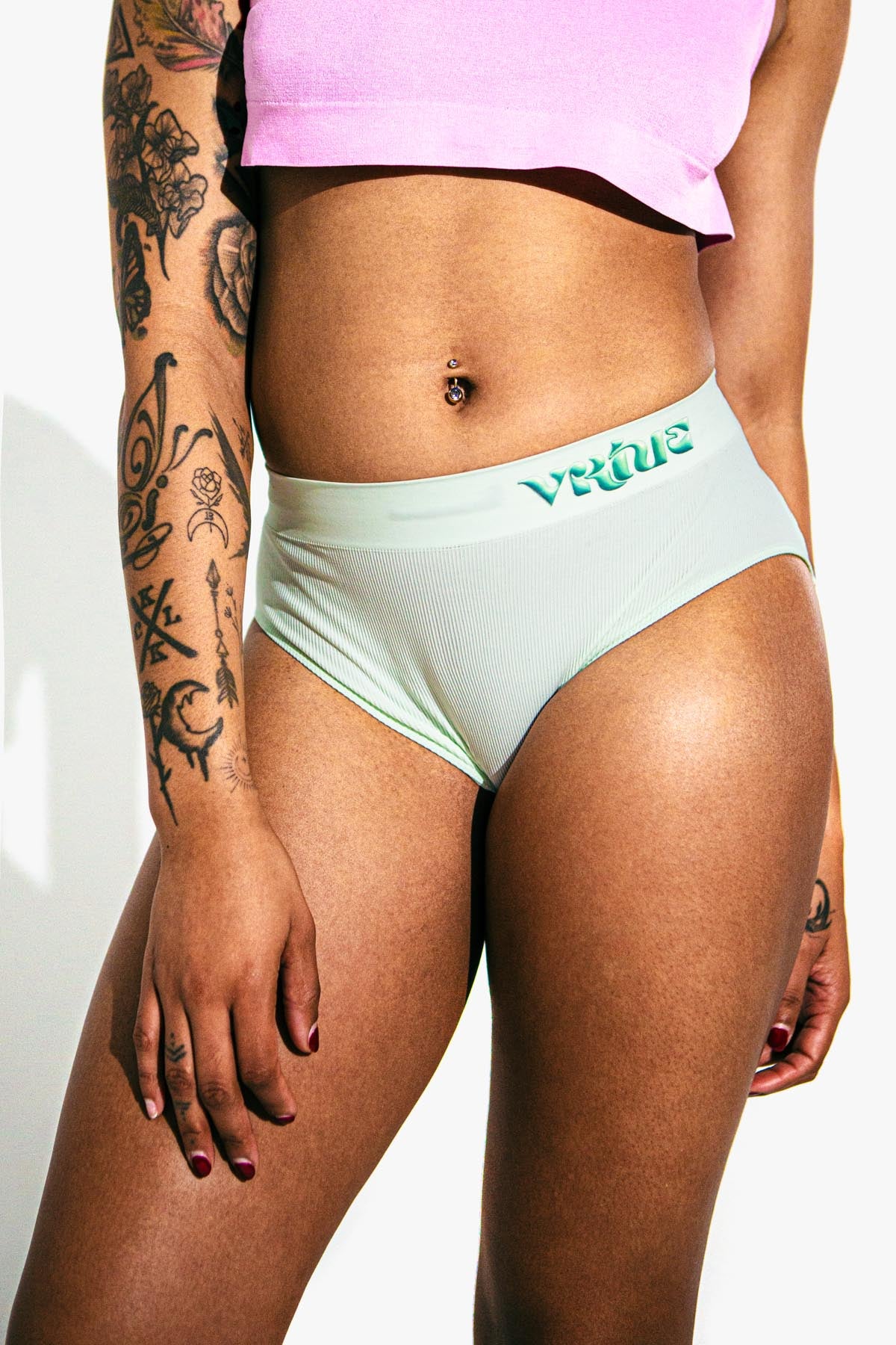 Virtue Model posing in Virtue Taffy Sheer Knit Crop Top and Mint Rib Knit Compact Fit Strap Brief Front View Close