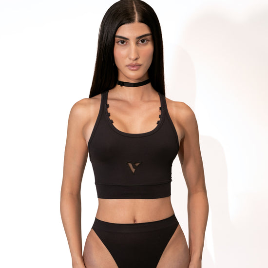 Model wearing the black Compression Crop Top, front view — Color: Black