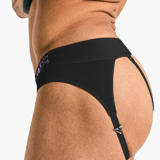 Model wearing the black Sculpt Jockstrap Rib Brief, side-back view — Fabric: Rib — Color: Black