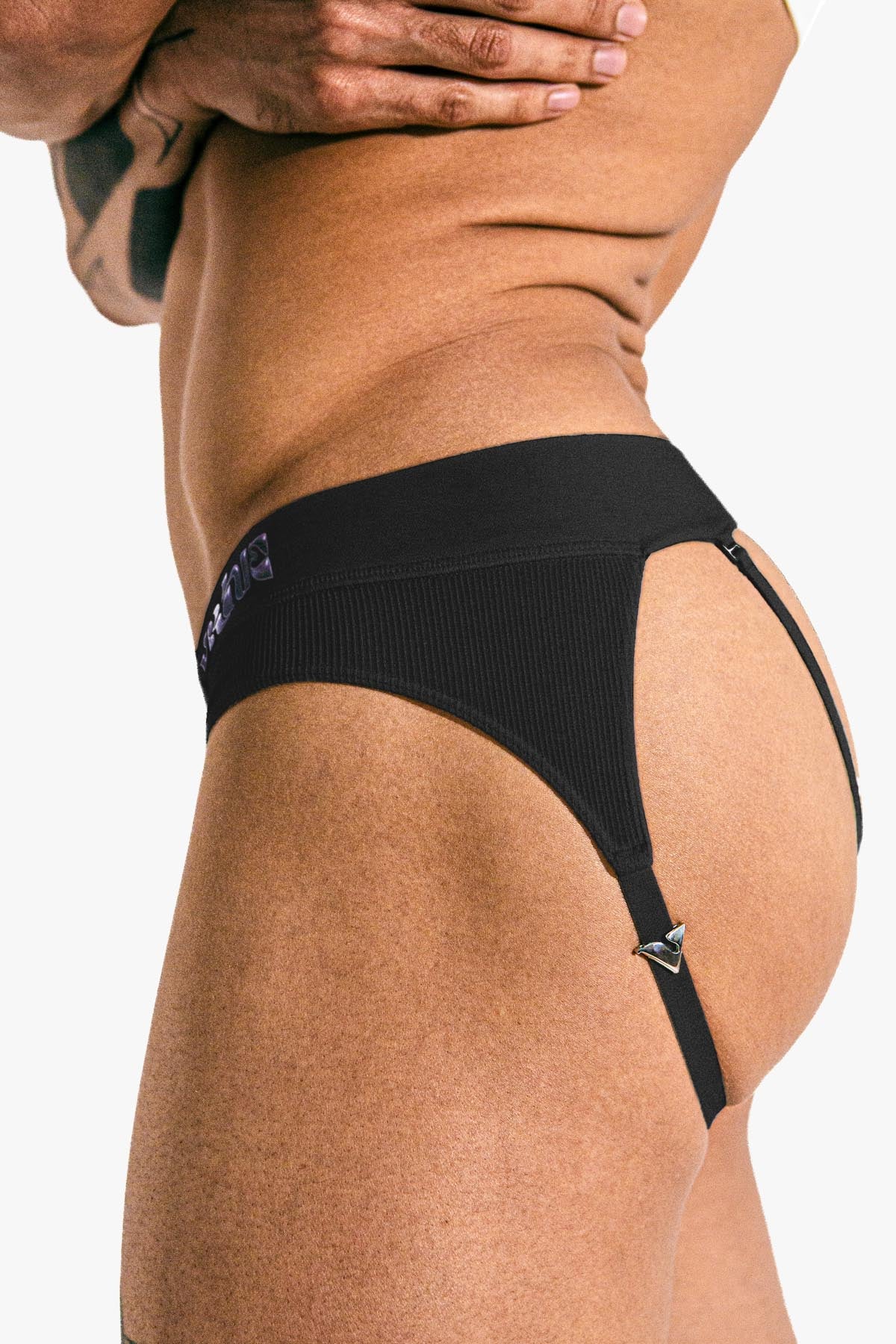 Model wearing the black Sculpt Jockstrap Rib Brief, side-back view — Fabric: Rib — Color: Black