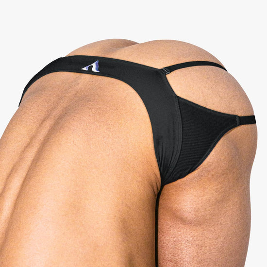 Close-up of a model wearing the black Sculpt Jockstrap Rib Brief, front fit — Fabric: Rib — Color: Black