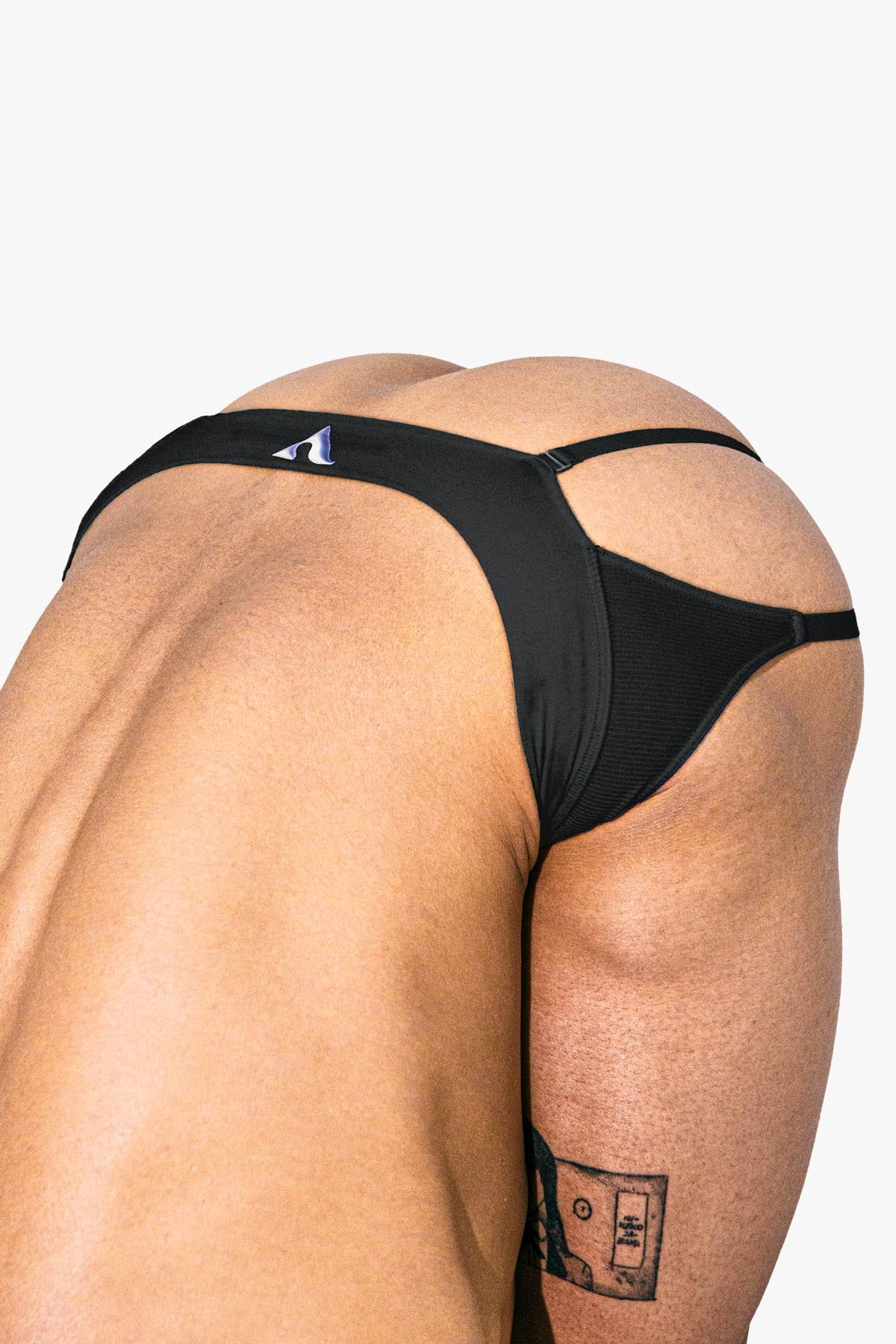 Virtue model Te Johnson wearing Virtue black pouch strap briefs in Yoga pose